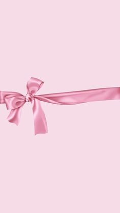 a pink ribbon tied with a bow on top of a pink background that looks like something out of space