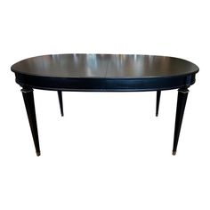 an oval table with two legs and a black top, on a white background is shown