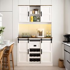 a kitchen with white cabinets and black counter tops