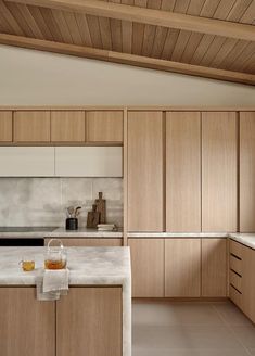 a kitchen with wooden cabinets and white counter tops