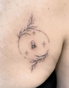 a woman's breast with a butterfly and leaves tattoo on her left side ribcage