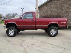 a red truck parked in front of a brick building