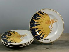 three plates with sun and moon designs on them