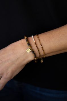 Add a touch of elegance to your wrist with our Light Tigers Eye Gold Bracelet. This dainty, adjustable piece features natural stone beads with delicate gold accents. The small stones add a touch of sophistication, making this bracelet a gorgeous addition to any outfit. Adjustable Gold Beaded Bracelets With Gemstone, Gold Stretch Bracelet With Natural Stones For Everyday, Brown Resizable Everyday Jewelry, Dainty Adjustable Hand-strung Gold Bracelet, Dainty Adjustable Gold Bracelet Hand-strung, Adjustable Yellow Gold Beaded Bracelets With Natural Stones, Adjustable Yellow Gold Bracelet With Natural Stones, Adjustable Minimalist Gold Bracelet Hand-strung, Dainty Gold Beaded Bracelet With Natural Stones