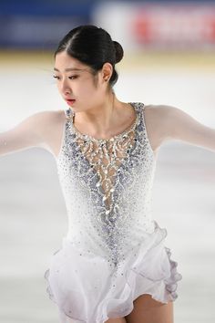 a female figure skating on an ice rink