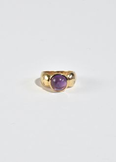 Stunning vintage gold ring with round amethyst cabochon and petite sapphire detail. Stamped 10k. Material: 10k gold, amethyst, sapphire. We recommend storing in a dry place and periodic polishing with a cloth. Amethyst Center Stone Birthstone Ring In Yellow Gold, Yellow Gold Amethyst Ring With Round Cut, Heirloom Amethyst Ring In Yellow Gold With Bezel Setting, Classic Amethyst Ring Stamped 14k, 14k Gold Dome Ring With Cabochon, Yellow Gold Birthstone Ring With Amethyst Center Stone, Heirloom 14k Gold Round Cut Amethyst Ring, Hallmarked Yellow Gold Amethyst Ring, Heirloom Gold Amethyst Ring With Bezel Setting