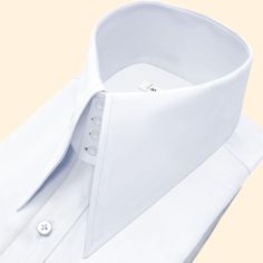 High Long Pointed Collar Tailor-Made On Order shirt 𝘈 𝘸𝘩𝘪𝘵𝘦 𝘩𝘪𝘨𝘩-𝘤𝘰𝘭𝘭𝘢𝘳 𝘴𝘩𝘪𝘳𝘵 𝘪𝘴 𝘢 𝘤𝘭𝘢𝘴𝘴𝘪𝘤 𝘢𝘯𝘥 𝘵𝘪𝘮𝘦𝘭𝘦𝘴𝘴 𝘸𝘢𝘳𝘥𝘳𝘰𝘣𝘦 𝘴𝘵𝘢𝘱𝘭𝘦 𝘵𝘩𝘢𝘵 𝘦𝘹𝘶𝘥𝘦𝘴 𝘴𝘰𝘱𝘩𝘪𝘴𝘵𝘪𝘤𝘢𝘵𝘪𝘰𝘯 𝘢𝘯𝘥 𝘦𝘭𝘦𝘨𝘢𝘯𝘤𝘦. 𝘛𝘩𝘪𝘴 𝘵𝘺𝘱𝘦 𝘰𝘧 𝘴𝘩𝘪𝘳𝘵 𝘧𝘦𝘢𝘵𝘶𝘳𝘦𝘴 𝘢 𝘤𝘰𝘭𝘭𝘢𝘳 𝘵𝘩𝘢𝘵 𝘴𝘵𝘢𝘯𝘥𝘴 𝘶𝘱 𝘢𝘯𝘥 𝘦𝘯𝘤𝘪𝘳𝘤𝘭𝘦𝘴 𝘵𝘩𝘦 𝘯𝘦𝘤𝘬, 𝘱𝘳𝘰𝘷𝘪𝘥𝘪𝘯𝘨 𝘢 𝘳𝘦𝘧𝘪𝘯𝘦𝘥 𝘢𝘯𝘥 𝘱𝘰𝘭𝘪𝘴𝘩𝘦𝘥 𝘭𝘰𝘰𝘬. 𝘛𝘩𝘦 𝘤𝘳𝘪𝘴𝘱 𝘸𝘩𝘪𝘵𝘦 𝘤𝘰𝘭𝘰𝘳 𝘰𝘧 𝘵𝘩𝘦 𝘴𝘩𝘪𝘳𝘵 𝘪𝘴 𝘷𝘦𝘳𝘴𝘢𝘵𝘪𝘭𝘦 𝘢𝘯𝘥 𝘱𝘢𝘪𝘳𝘴 𝘸𝘦𝘭𝘭 𝘸𝘪𝘵𝘩 𝘢 𝘷𝘢𝘳𝘪𝘦𝘵𝘺 𝘰𝘧 𝘴𝘵𝘺𝘭𝘦𝘴 𝘢𝘯𝘥 𝘤𝘰𝘭𝘰𝘳𝘴, 𝘮𝘢𝘬𝘪𝘯𝘨 𝘪𝘵 𝘢𝘯 𝘪𝘥𝘦𝘢𝘭 𝘤𝘩𝘰𝘪𝘤𝘦 𝘧𝘰𝘳 𝘣𝘰𝘵𝘩 𝘧𝘰𝘳𝘮𝘢𝘭 𝘢𝘯𝘥 𝘤𝘢𝘴𝘶𝘢𝘭 𝘰𝘤𝘤𝘢𝘴𝘪𝘰𝘯𝘴. 𝘛𝘩𝘦 𝘴𝘩𝘪𝘳𝘵 𝘪𝘴 𝘵𝘺𝘱𝘪𝘤𝘢𝘭𝘭𝘺 𝘮 Luxury Business Tops With Collar, Luxury White Shirt With Fold Down Collar, Luxury White Shirt With Concealed Placket, Luxury Business Tops With Fold Down Collar, Luxury Business Top With Fold Down Collar, White Slim Fit Shirt With Concealed Placket, Solid Business Tops With Collar, Luxury White Semi-formal Top, Classic White Fitted Collars