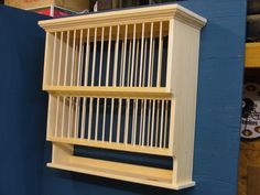 a blue wall with a wooden shelf on it