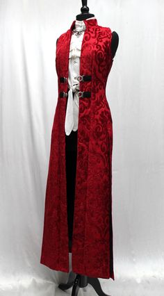 Gorgeous! A dramatic women's cassock coat made in lush red velvet print fabric. Sleeveless with a classic stand-up collar and a slimming fit. Slits in the back sides and front for flowing ease of movement. Fastens in front with two silver metal buckles at mid-section and fully lined with sleek black satin. Comes in sizes Small-3X. Size measurements: Small - Chest 34" Waist 30" Hips 38" Medium - Chest 36" Waist 32" Hips 40" Large - Chest 38" Waist 34" Hips 42" XL - Chest 40" Waist 36" Hips 44" XXL - Chest 43" Waist 39" Hips 47" 3X - Chest 46" Waist 41" Hips 50" Purple Vests, Holiday Clothes, Teased Hair, Fashion Journals, Red And Silver, Vest Coat, Really Cute Outfits, Fantasy Clothing, Fantasy Fashion