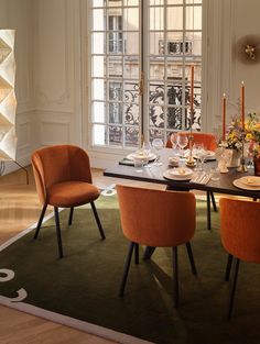 an elegant dining room with orange chairs