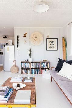 a living room filled with furniture and books