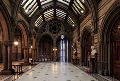 the inside of an old building with stained glass windows and arches on the ceiling is shown