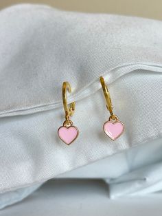 Pink heart earrings (hypoallergenic, 18k gold plated, and tarnish resistant) * huggie diameter: 14mm * heart dimensions: 7x8 mm also available in red: https://www.etsy.com/listing/1115612990/red-heart-huggies-hypoallergenic-tarnish * 30% of profits donated * ships in environmentally friendly packaging * free shipping over $35 * comes with a free butterfly sticker * ig: @jewelry.by.marina Trendy Pink Heart Earrings, Trendy Pink Heart Charm Earrings, Pink Heart Earrings Aesthetic, Cute Pink Pierced Heart Earrings, Sticker Ig, Pink Heart Charm Earrings, Indie Earrings, Heart Huggies, Hoops With Charms