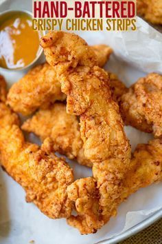 fried chicken sticks on a plate with dipping sauce