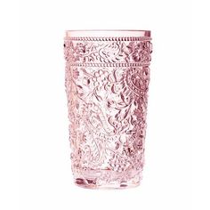 a pink glass vase sitting on top of a white table