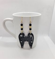 3D Printed Black Cat dangle earrings!   Cat is 3D printed with black Polylactic Acid (PLA), which is an environmentally friendly filament.  It is derived from crops such as corn and sugarcane, PLA is renewable and most importantly biodegradable. The earrings have a gold ear wire with black and gold glass beads, a 3.7 inch drop in length, cat is 0.8 inches width. Cute black cat created by Holly and Sylvia, uniquely for Cady's Treasures! Black Cat Design Drop Earrings, Cat 3d Print, Black Cat Earrings, Cat 3d, Cozy Cat, Cute Black Cat, Cute Black Cats, Love Charms, Cat Earrings