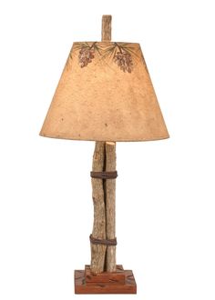 a lamp that is sitting on top of a wooden stand with a light shade over it