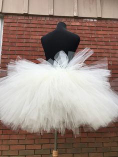 "This listing includes an ivory tutu with an ivory satin bow also includes the rose gold accent bow clip. This listing if for waist sizes 45 1/2 up to 55 1/2\" can be made larger if interested contact me for a special listing. Other colors also available. The ivory tutu with the rose gold bow clip has a longest length of 18\" and top layer of 13\". The ivory tutu with just the satin bow is the 13-18\" length range with a longest layer of 15\" and top layer of 12\". Tutu can be all one length or White Tulle Petticoat For Party, Cream Tulle Skirt Tutu Dress For Baptism, White Fitted Tutu Dress For Wedding, White Ballet Tutu Dress For Party, Cream Tulle Tutu Dress For Wedding, White Tulle Tutu Dress For Wedding, White Tulle Skirt For Party, White Tulle Tutu Dress For Party, White Balletcore Skirt For Party