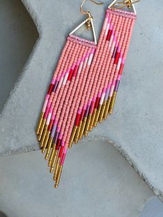 a pair of pink and gold beaded earrings