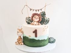 a birthday cake with a lion and giraffe decoration