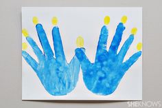 two handprints are shown on a piece of paper that has been made to look like blue and yellow hands