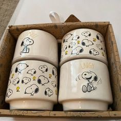 three ceramic cups with snoopy characters on them