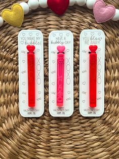 three valentine's day candy tubes are sitting on a wicker basket