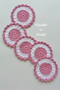 three crocheted coasters in pink and white with circles on the center, sitting next to each other