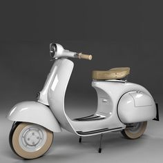 a white scooter sitting on top of a gray floor