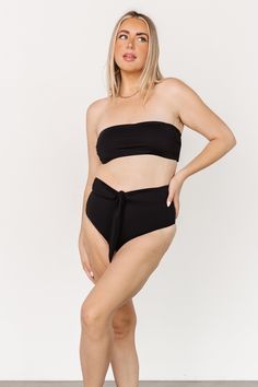 Baltic Born best-seller! Classic black color Tie back bandeau style bikini top Removable padded cups Adjustable to fit most body types 80% Nylon, 20% Spandex Hand wash cold, lay flat to dry Trina is 5'6, cup size 32D, size 2 and is wearing size S Victoria is 5'7, cup size 34D, size 8/10 and wearing size L Bandeau Swimwear With Removable Bra Pads For Sunbathing, Bandeau Swimwear With Removable Bra Pads For Poolside, Black Strapless Tankini For Pool, Black Strapless Tube Top For Poolside, Black Strapless Swimwear, Strapless Black Tankini For Pool, Solid Strapless Swimwear With Removable Bra Pads, Solid Color Bandeau Swimwear With Seamless Design, Solid Color Bandeau Swimwear Seamless