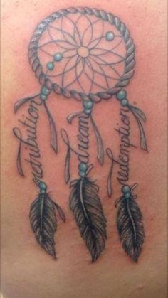 the back of a woman's shoulder with a dream catcher tattoo design on it