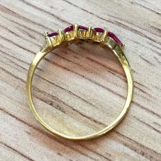 Metal: 14kt Yellow Gold Stone: Ruby and Diamond Ruby Weight: Approx. .55 Carats Diamond Weight: N/A Weight of entire piece: 1.50 Grams Ring Size: 7 Sizable: Yes. Please state in size/personalization box. Age: Vintage Condition: Excellent Marquise Cut Multi-stone Yellow Gold Diamond Ring, Pear-shaped Brilliant Cut Yellow Gold Ruby Ring, Classic Marquise Ruby Ring With Vvs Clarity, Formal Gold Rings With Ruby, Formal Gold Ruby Rings, 14k Gold Pear-shaped Ruby Ring, Fine Jewelry 14k Gold Pear-shaped Ruby Ring, Gold Ruby Ring Stamped 14k, Luxury Yellow Gold Ruby Ring With Marquise Cut