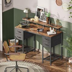 a room with a desk and chair, potted plants on the floor and pictures hanging on the wall