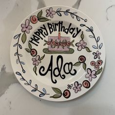 a happy birthday plate with a cake on it