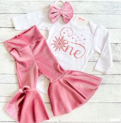 "First Birthday Outfit Girl, Winter Birthday Flare Pant Outfit, Pink Velvet Smash Cake Outfit, Niece Aunt Gift You may choose: ~Darling rose gold snowflake \"One\" bodysuit as shown. Available in short or long sleeve. (Personalization is included/optional) ~Adorable velvet flare bell bottoms! Handmade here in our studio. ~Matching fabric bow/headband MATCHING FAMILY SHIRTS SOLD SEPARATELY AND AVAILABLE BY CLICKING ON LINK BELOW: https://www.etsy.com/listing/470391889/winter-first-birthday-snowfl First Birthday Party Winter Theme, Winter 1st Birthday Theme, Winter Onederland Outfit Girl, Winter Onederland Party Girl Outfit, Winter Onderland Birthday Girl, Girl 1st Birthday Party Ideas Winter, 1st Birthday Girl December, 1st Birthday Girl Winter Theme, First Birthday Winter Onederland