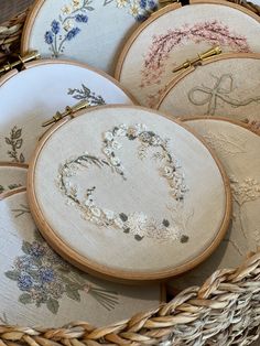 some embroiderys are in a basket on the table