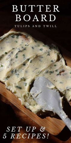 a wooden cutting board topped with mashed potatoes covered in gravy and a spatula