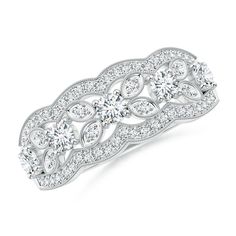 a white gold and diamond ring with an intricate design on the front, surrounded by round brilliant cut diamonds