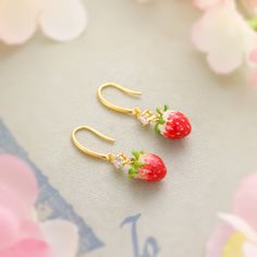 Indulge in the sweetness of these luscious strawberry earrings. Featuring a delicate enamel finish and shimmering cubic zirconia, these cheerful earrings brighten up your look with a touch of nature-inspired style. Perfect for adding a pop of freshness and fashion to your summer vibes! DETAILS Plating: 18K Gold Materials: 18K Gold on Brass, Enamel, Cubic Zirconia Size: 1.39 "*0.39"(3.4c m*1cm) Weight: 6.4g Sweet Drop Earrings As A Gift, Sweet Drop Earrings For Gift, Sweet Hypoallergenic Earrings As Gift, Sweet Hypoallergenic Earrings For Gifts, Cute Fruit Design Earrings For Gift, Sweet Drop Earrings Jewelry Gift, Sweet Jewelry With Fruit Design For Gift, Cute Enamel Drop Earrings Jewelry, Cute Dangle Enamel Earrings