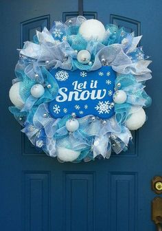 a blue door with a snow wreath on it