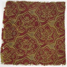 an old red and gold cloth with designs on it