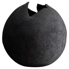 a large black ball shaped object on a white background