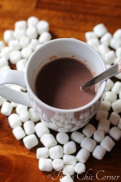 hot chocolate and marshmallows arranged in the shape of a heart