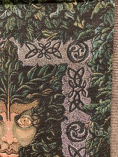 an image of a woman's face on a piece of fabric with leaves and vines