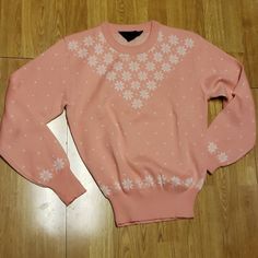 Long sleeve crew neck sweater with wide ribbed cuffs and hem. Wool and acrylic blend. Pink with white snowflake pattern. Excellent vintage condition. 19.5 in pit to pit. Crew Neck Sweater For Spring Cold Weather, Vintage Winter Sweater With Ribbed Cuffs, Pink Winter Tops For Cold Weather, Fitted Fair Isle Pattern Crew Neck Top, Pink Fair Isle Crew Neck Sweater, Pink Crew Neck Sweater With Fair Isle Pattern, Vintage Pink Tops For Winter, Pink Fair Isle Sweater For Winter, Pink Fair Isle Winter Sweater