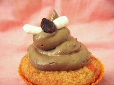 a cupcake topped with chocolate frosting and bananas