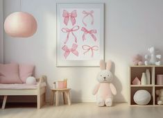 there is a pink room with white furniture and decorations on the walls, along with a bunny stuffed animal