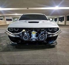 the front end of a white sports car