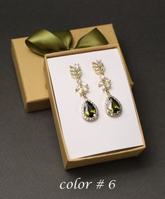 "Dark Peridot bridal jewelry earrings necklace bridesmaids gifts Olive green wedding jewelry set bridal jewelry Olive bridal necklace earrings bracelet set Custom color: AAA Dark Peridot (color #6) cubic zirconia crystal earrings, necklace, and leaf bracelet set.  Other stone colors are available for you to choose, please see last picture for color chart, and leave note for color number (#) you need.  Earrings length: about 1.6 inches (40mm) in length.  Necklace: Matching pendant 16-19 inches adjustable length, or other lengths you need. Please leave a note for different length.  Bracelet: Clear CZ leaf bracelet 6.5-7.5 inches adjustable with extender links. If you need different length, please let me know.  They are in anti-tarnish in high quality gold, rose gold, or white gold (silver co Cubic Zirconia Jewelry Sets With Drop Earrings For Gifts, Green Cubic Zirconia Jewelry Sets For Weddings, Cubic Zirconia Jewelry Set With Matching Earrings, Green Cubic Zirconia Wedding Jewelry, Green Cubic Zirconia Jewelry For Wedding, Green Teardrop Jewelry Sets For Anniversary, Elegant Teardrop Jewelry For Wedding Gift, Green Elegant Drop Earrings, Green Elegant Wedding Earrings