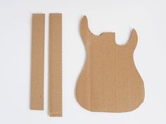 an unfinished guitar body and parts to make it look like they have been cut out